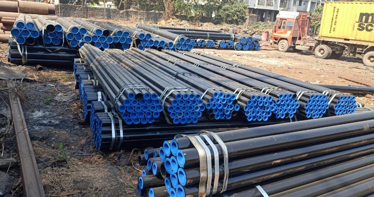 Bundled seamless carbon steel pipes stacked in industrial storage yard