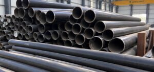 Bundled seamless carbon steel pipes stacked in industrial storage yard